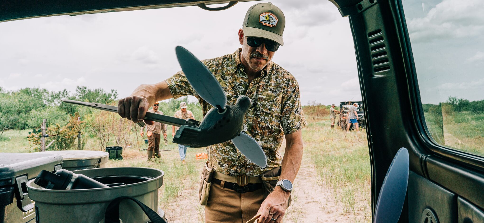 Guy in a lightweight button down in olive
